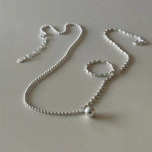 Minimalist 925 silver beaded necklace featuring a polished round ball pendant on light background