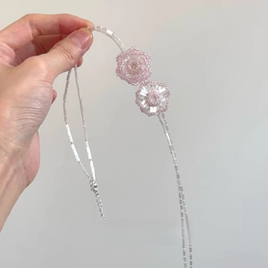 Double-layered beaded necklace with pink flower charms and adjustable silver chain