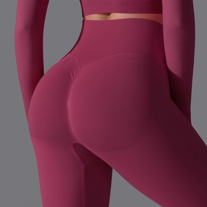 Detail view of the seamless high-waist scrunch butt design on dark red yoga pants