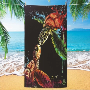 Microfiber beach towel with colorful sea turtles hanging by the ocean and palm trees
