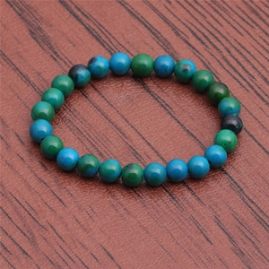 Natural phoenix lapis lazuli beaded bracelet on a rustic wood background