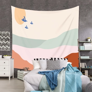 Detail of bohemian tapestry with sunset and birds hanging as a cozy bedroom backdrop