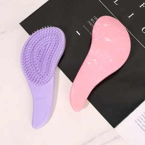 Ergonomic marble pattern detangling hairbrushes in macaron purple and pink on marble