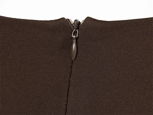 Close-up of the smooth dark brown concealed zipper on high-density knit fabric