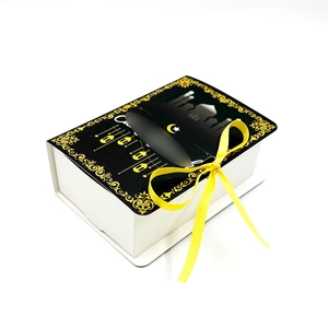 Detail of Ramadan gift box with gold star moon pattern, mosque silhouette and yellow ribbon