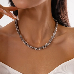 Detailed view of silver beaded choker necklace worn on neck featuring metallic texture