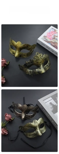 Close-up of vintage Roman masks with gold scroll textures and crown details