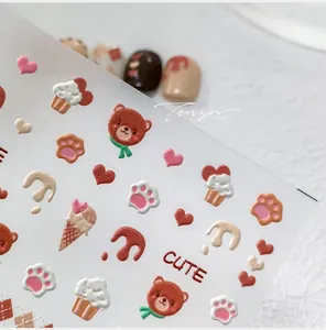 Macro view of 5D embossed bear and ice cream nail stickers with cute 3D textures