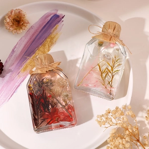 Preserved flower reed diffuser in transparent glass bottles with dried floral arrangements