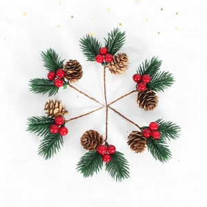 Macro of six artificial pine needles with red berries and mini pinecones for Christmas decor