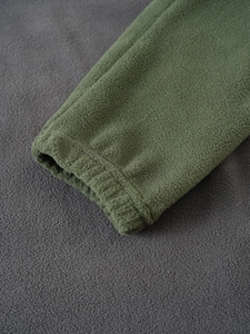 Detail of army green fleece tactical hoodie showing elastic cuff texture and fabric