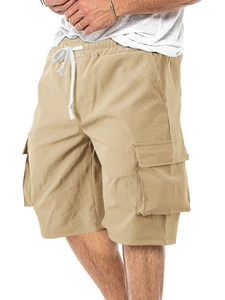 Detail of khaki cargo shorts showing drawstring waist and large side pockets