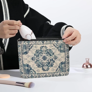 Bohemian paisley makeup bag in blue and beige fabric being used for cosmetics storage