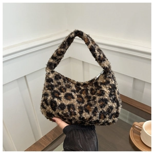 Close-up of leopard print plush tote bag showing the soft textured fabric and handheld style
