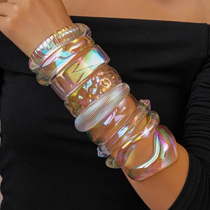 Macro detail of iridescent acrylic bangles showing geometric shapes and holographic gloss
