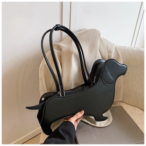 Close-up of black dachshund-shaped PU leather shoulder bag with smooth zipper closure