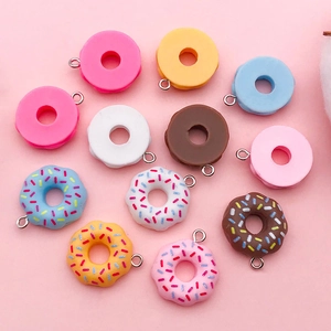 Flat lay of colorful resin donut charms with metal loops for DIY jewelry making