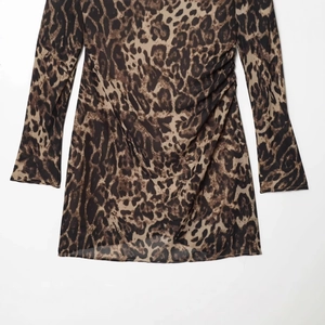 Slim fit long sleeve leopard print dress with ruched waist detail on white background