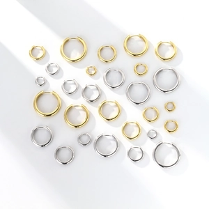 Flat lay view of various sizes and colors of S925 sterling silver hoop earrings
