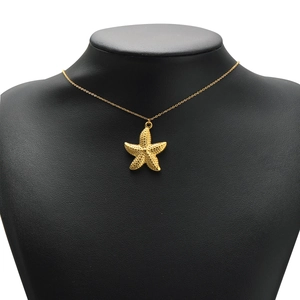Gold plated stainless steel starfish pendant necklace on professional black mannequin bust