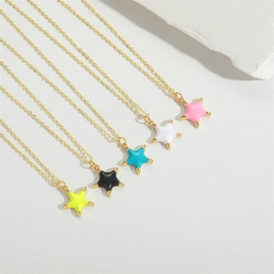 Detailed close-up of five colored star pendants on elegant gold chains in macro view