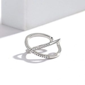 Macro view of adjustable silver cross ring featuring shimmering pavé cubic zirconia