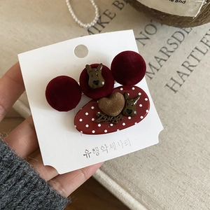 Detailed view of burgundy velvet hair clips with cartoon dog and Zsiga letter charms