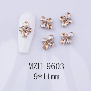 Detailed view of champagne crystal flower nail charms with 9x11mm size measurements