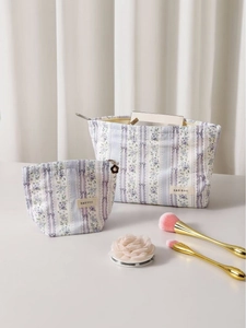 Floral print cosmetic bag set with purple flowers and lace bow details for travel