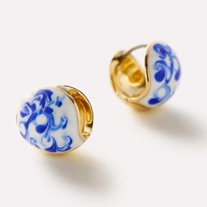 Elegant 18K gold hoop earrings with blue and white porcelain enamel texture on a white base