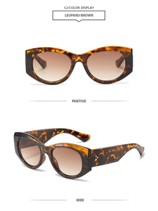 Detail of tortoise shell oval sunglasses with brown gradient lenses and metal rivet accents