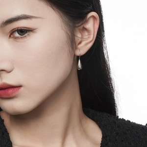 Minimalist silver S925 sterling silver water drop earrings shown on a female model