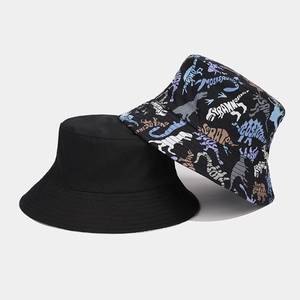 Detail view of twill cotton bucket hats in solid black and dinosaur cartoon print