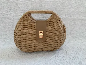 Detail of woven straw bag texture with leather flap and square gold buckle