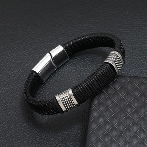 Men's punk black braided leather bracelet with silver magnetic clasp on leather backdrop