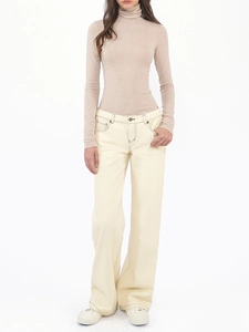 Slim fit tencel wool turtleneck sweater paired with high-waist wide-leg cream trousers