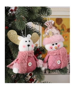 Close-up of pink festive plush dolls with sequins hanging on a Christmas tree branch
