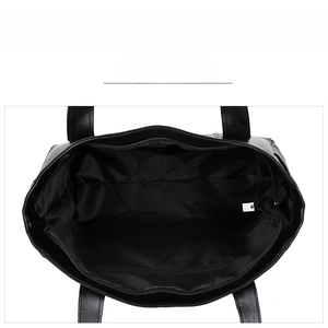 Internal view of black tote bag showing main compartment with multiple pockets