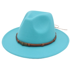 Detail of blue felt hat featuring brown leather band and antique bronze skull emblem