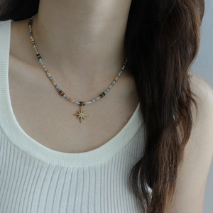 Star pendant necklace with blue tiger eye beads and stainless steel chain on model