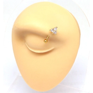 Close-up of golden eyebrow piercing with three sparkling zircons on realistic silicone model