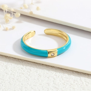 Detail of 18K gold plated ring with blue enamel coating and micro-set zircon stone