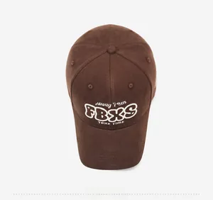 Top down macro view of dark brown baseball cap with white letter embroidery details