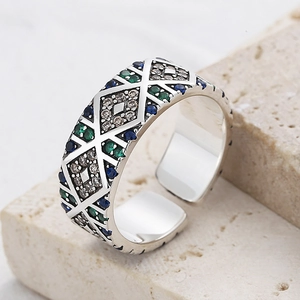Macro shot of s925 silver angel eye ring with colorful zircons and geometric hollow patterns