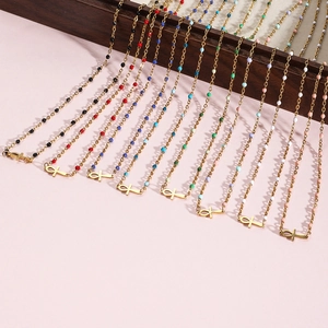 Detailed rows of colorful beaded gold necklaces with Ancient Egyptian Ankh cross pendants