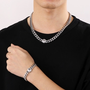 Detail of 10mm silver Cuban chain and bracelet set with inlaid Tai Chi pendant on neck