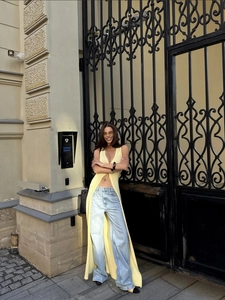 Slim fit pale yellow long knit cardigan paired with high waisted wide leg blue jeans
