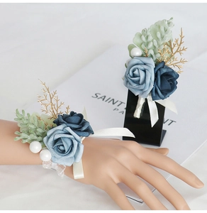 Detailed view of blue artificial silk wrist corsage and boutonniere for weddings