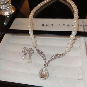 Elegant jewelry set with teardrop pearl necklace and diamond stud earrings in a gift box