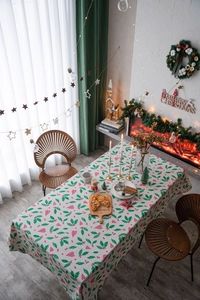 Close-up of heart and holly leaf prints on a festive cream rectangle tablecloth